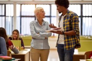 = female professor discusses lesson with black student